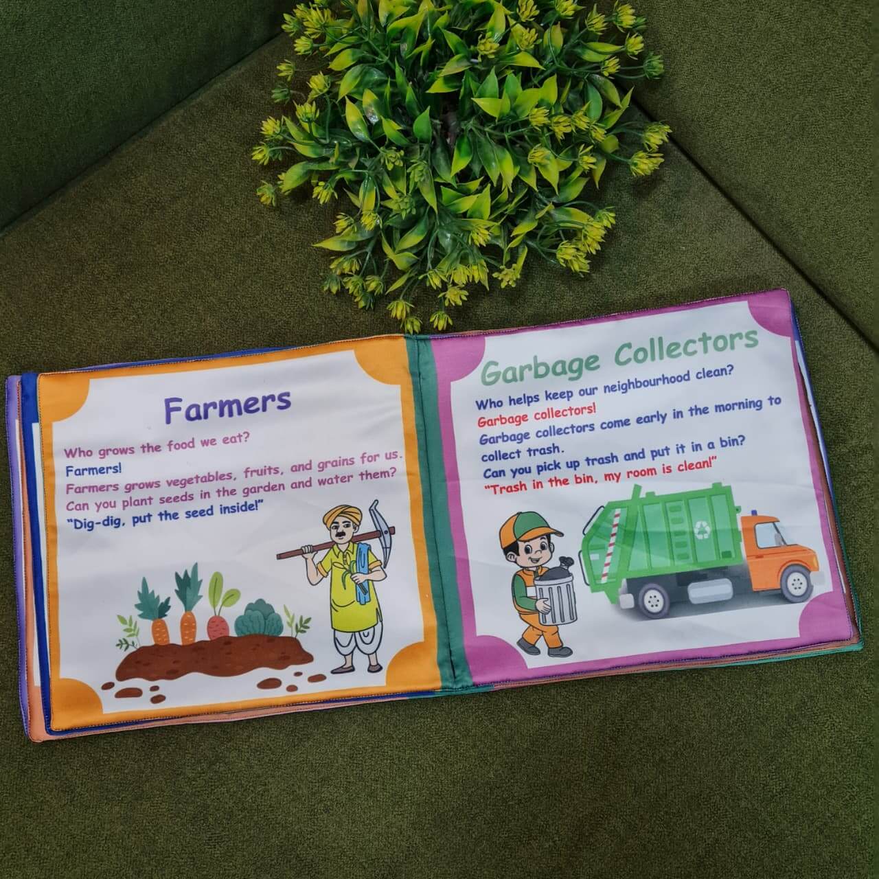 An open "Our Helping Heroes" fabric book by Kidogen, displaying pages about "Police Officers" and "Doctors and Nurses" with illustrations of community helpers and descriptive text.