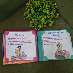 Our Helping Heroes" fabric book by Kidogen, featuring illustrations of a teacher, a farmer, a soldier, a fire truck, and a military vehicle, with the brand logo.