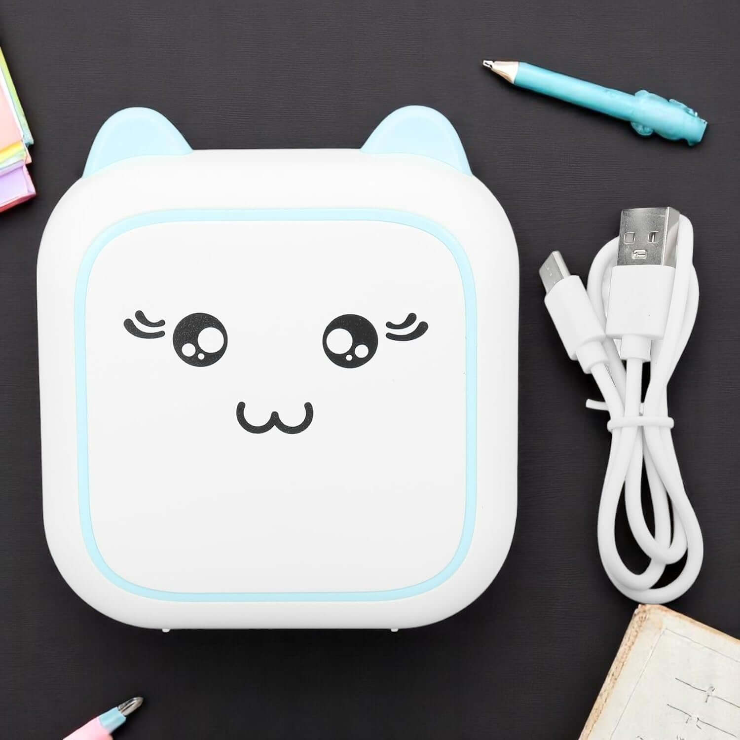 White mini inkless portable printer with cute cat face design and blue accents for kids www.usmile.toys