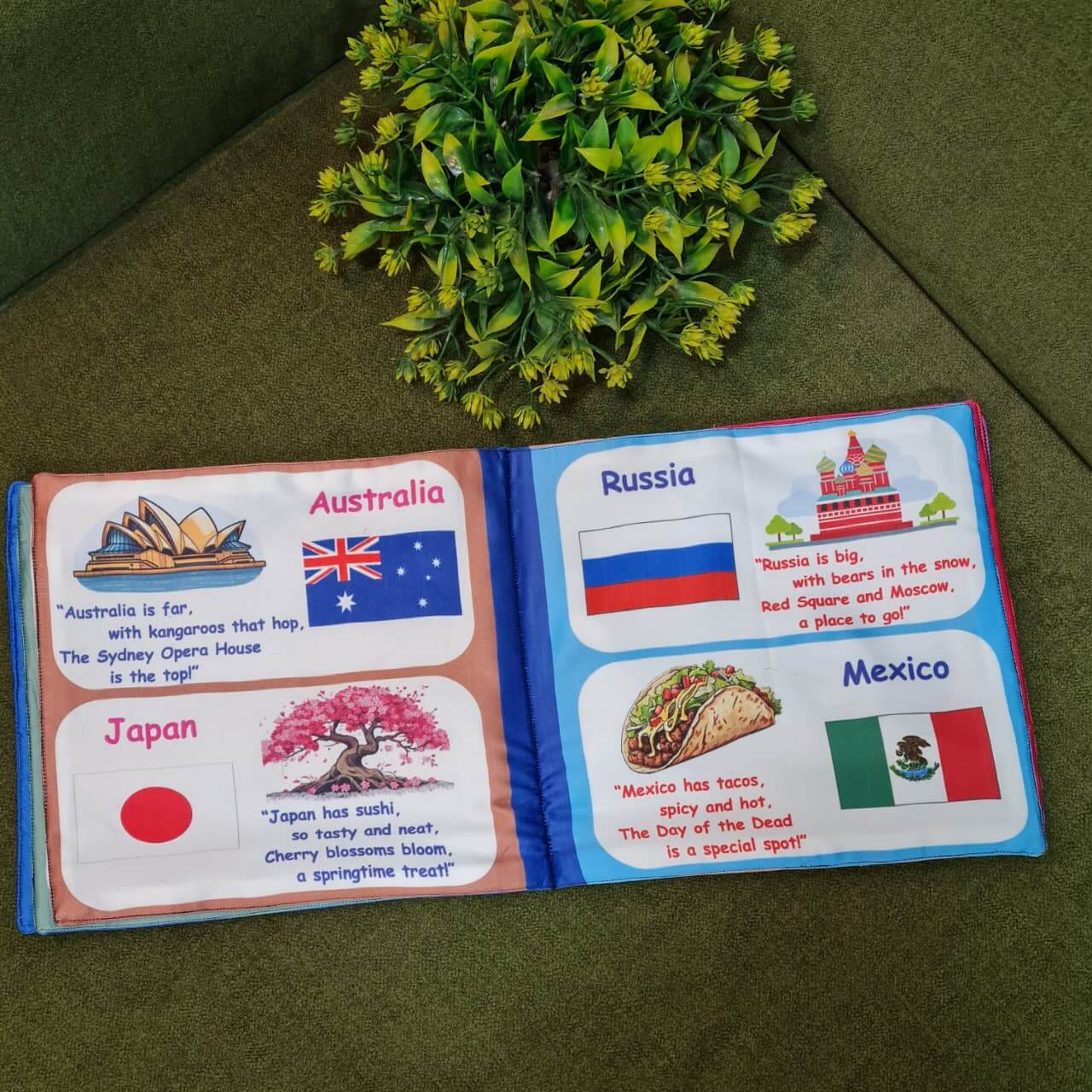 "Flag of the World" fabric book by Kidogen, displaying pages about India, USA, Italy, and the United Kingdom with their flags, landmarks, and descriptive rhymes.