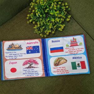 "Flag of the World" fabric book by Kidogen, displaying pages about India, USA, Italy, and the United Kingdom with their flags, landmarks, and descriptive rhymes.