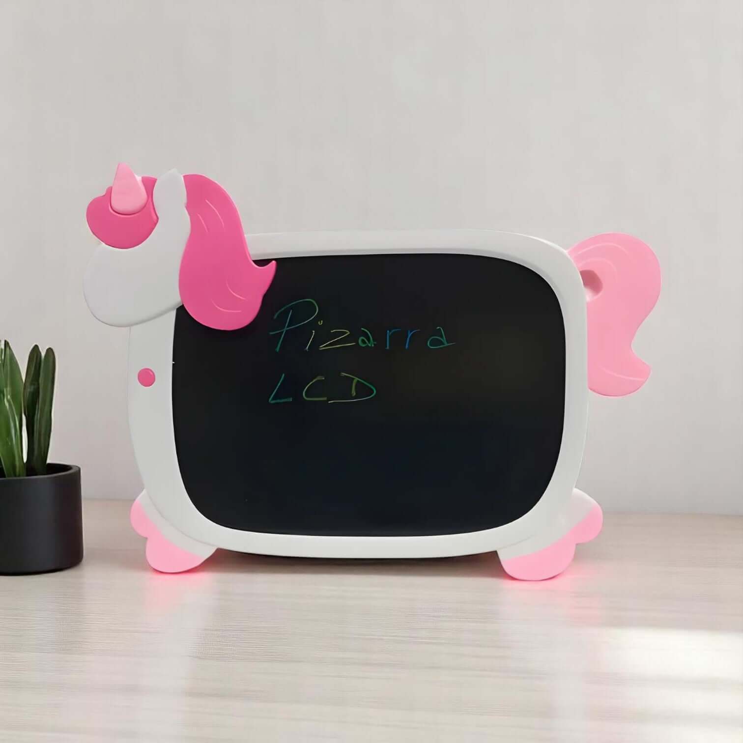 Magical unicorn-shaped LCD writing board for kids, featuring a white body with pink accents like the horn, mane, and hooves. The black screen displays "Pizarra LCD" written in green, making it a perfect reusable drawing tablet and educational toy for toddlers and children. www.usmile.com