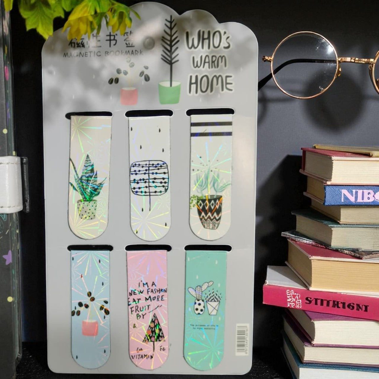 Set of bookmarks on a display card with books and glasses in the background