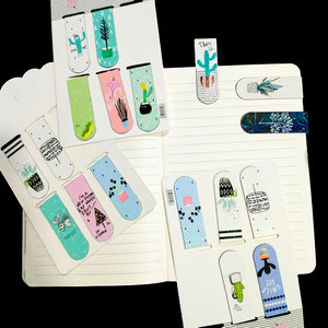 Set of colorful bookmarks with plant designs on a notebook