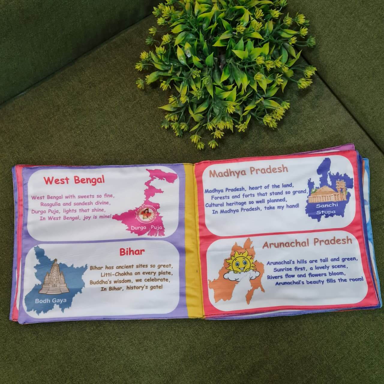 A flat lay of five Kidogen fabric books: "The Land of Many States," "Deep Blue Wonders: Under the Sea," "My Amazing Body," "Flag of the World," and "Our Helping Heroes."