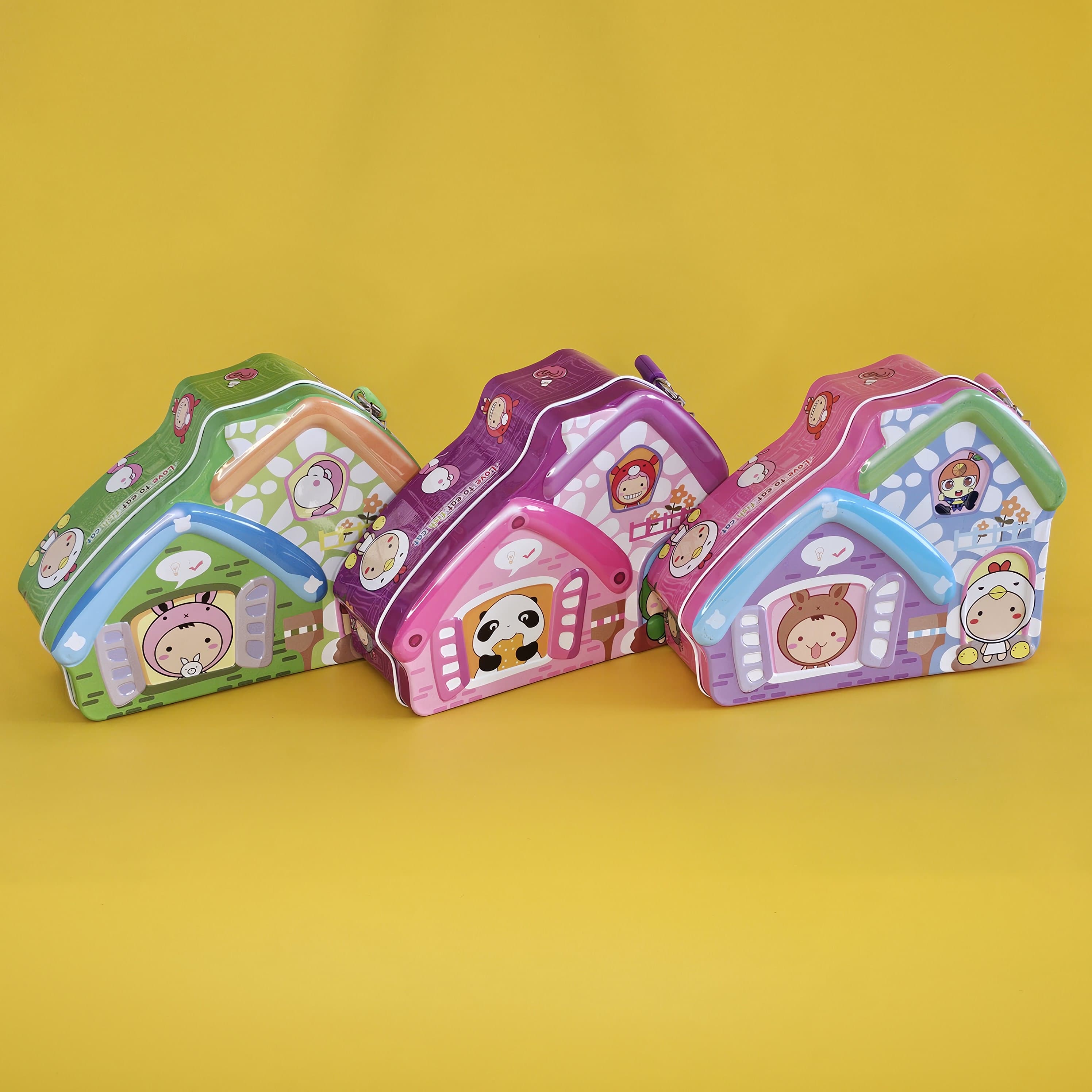 Adorable house-shaped metal money boxes for children with lock and keys, featuring cartoon animal characters. Secure savings for kids, shop at usmile.toys
