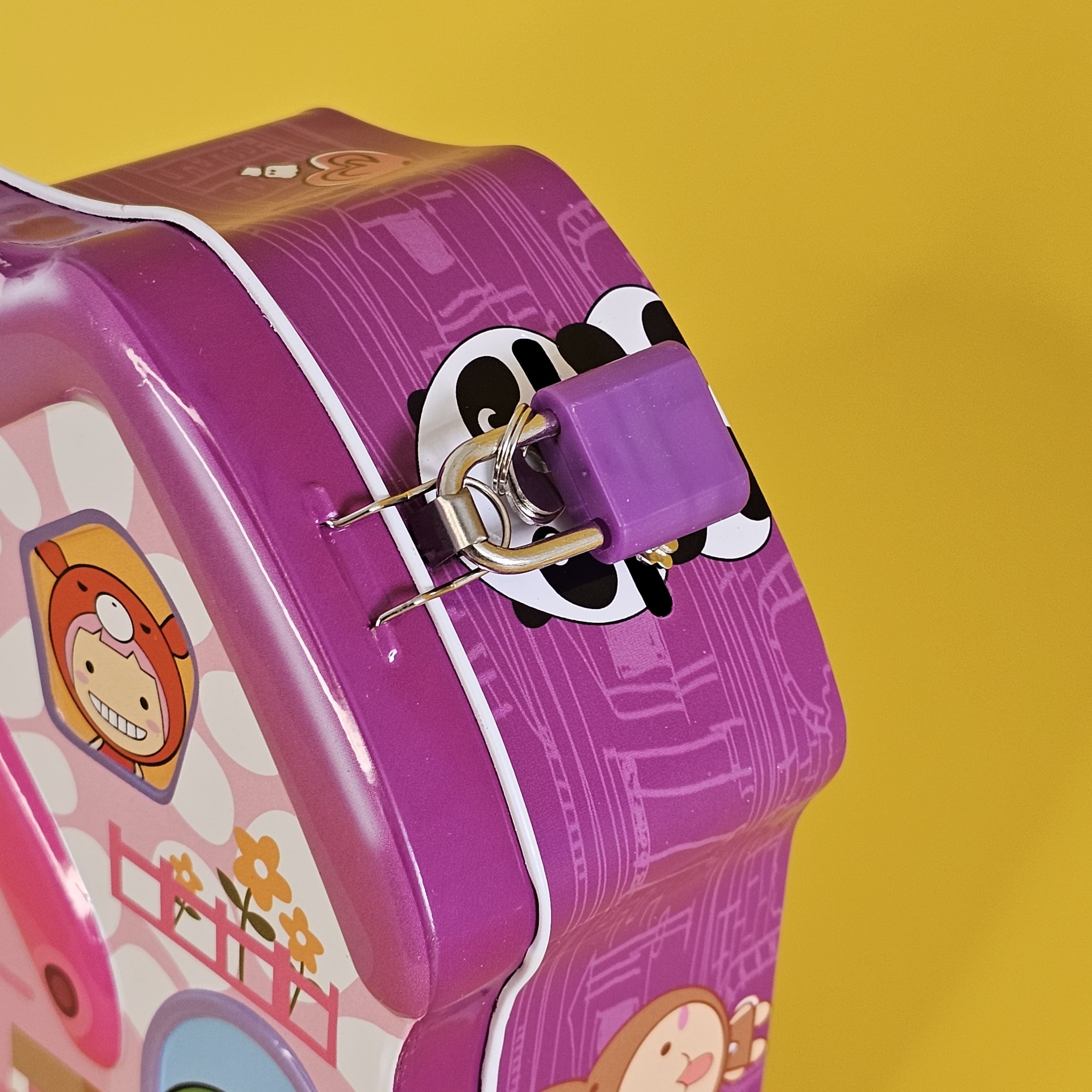 Kids' metal coin banks with locks, house shaped, in green, purple, and blue. www.usmile.toys