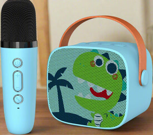 Cute blue mini karaoke portable Bluetooth speaker with a smiling green dinosaur design, paired with a matching wireless microphone for kids, by Usmile Toys." www.usmile.toys