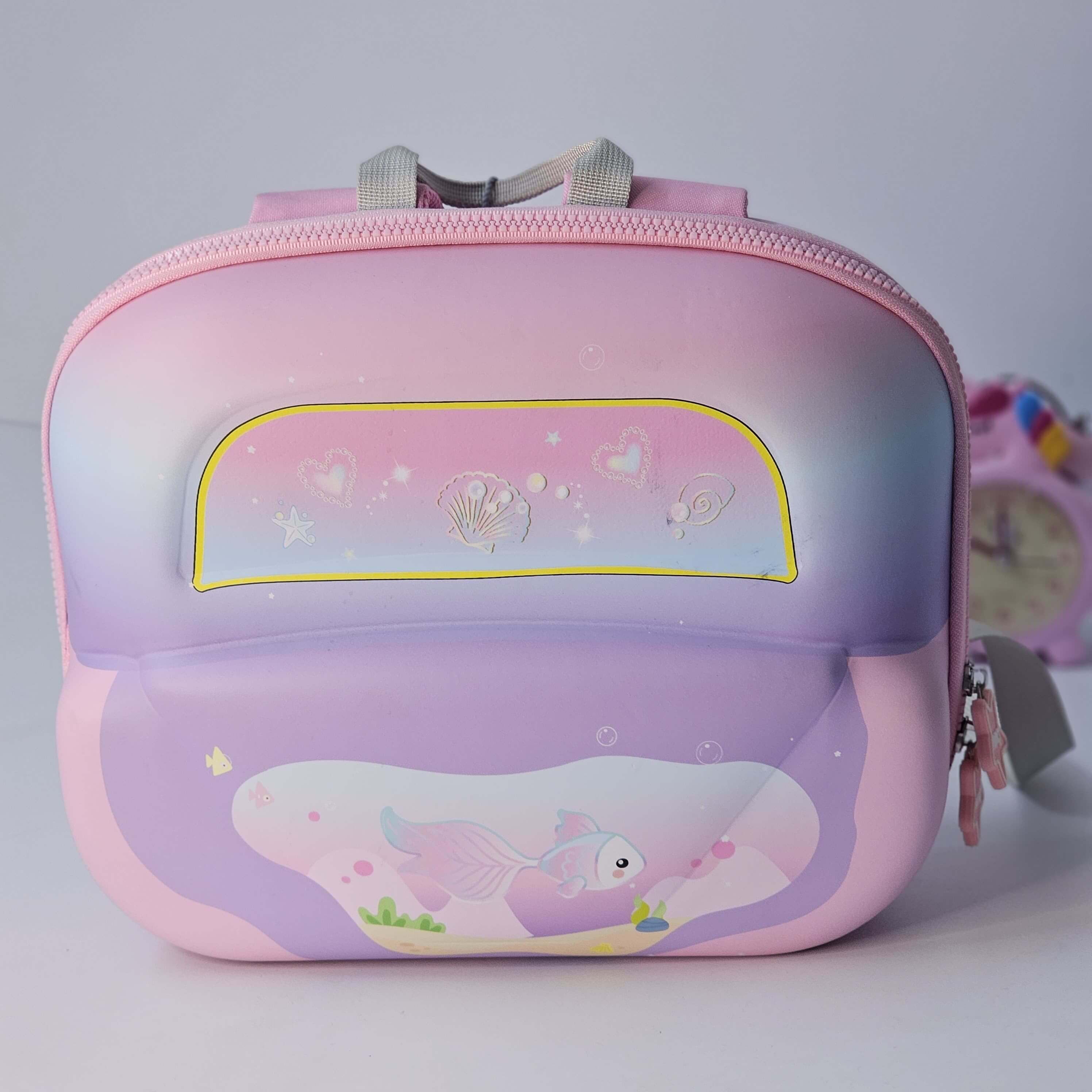 Pink and purple children's backpack with a cartoon design on a white background