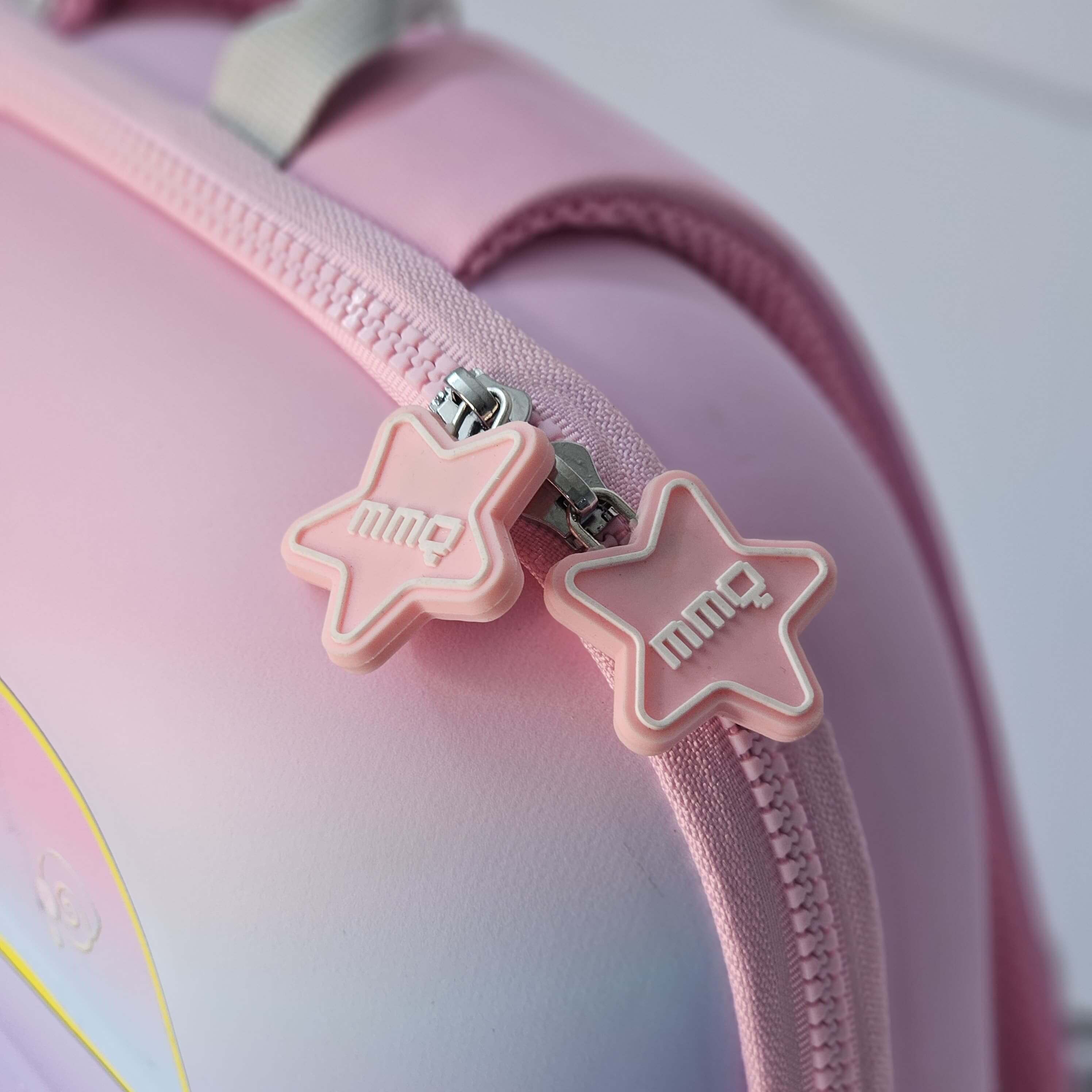 Pink star-shaped zipper pulls on a pink bag with 'mim' branding.