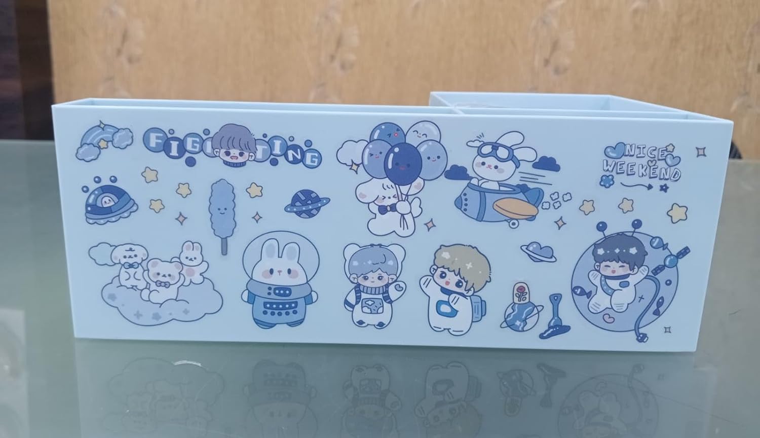 Cartoon character-themed product packaging on a reflective surface with a wooden background