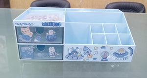 Clear plastic organizer with cartoon designs on a glass surface