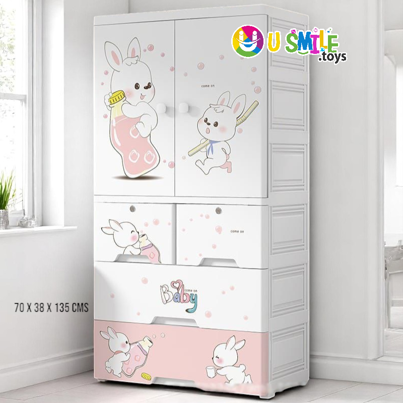 Premium Rabbit Baby Wardrobe (Almari) in white and pink, featuring cute cartoon bunnies and baby bottle illustrations. This plastic cupboard with multiple drawers and double doors measures 70 x 38 x 135 cm, perfect for nursery storage and organizing baby clothes on usmile.toys. www. usmile.toys