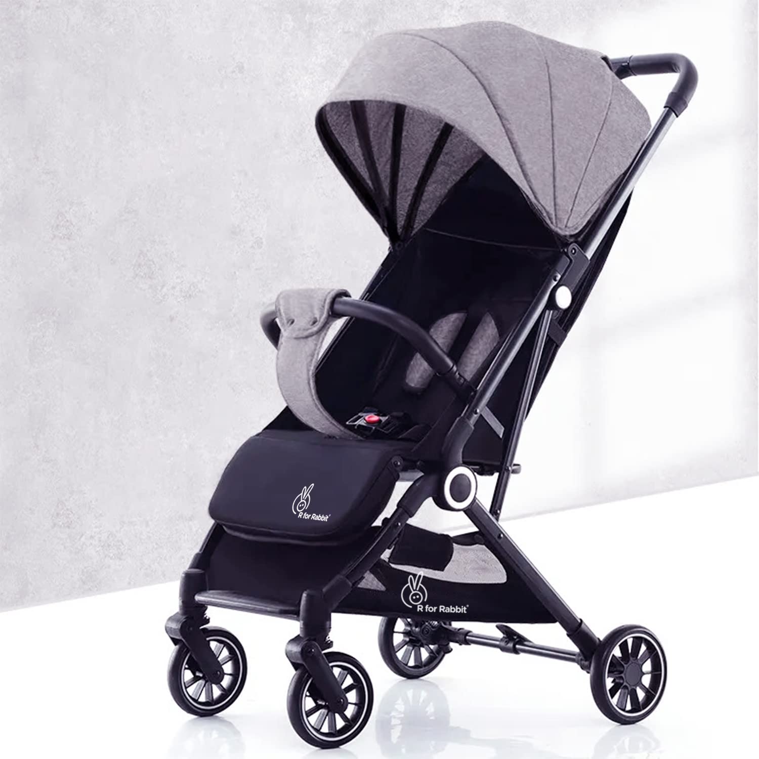 Black and gray baby stroller on a white background