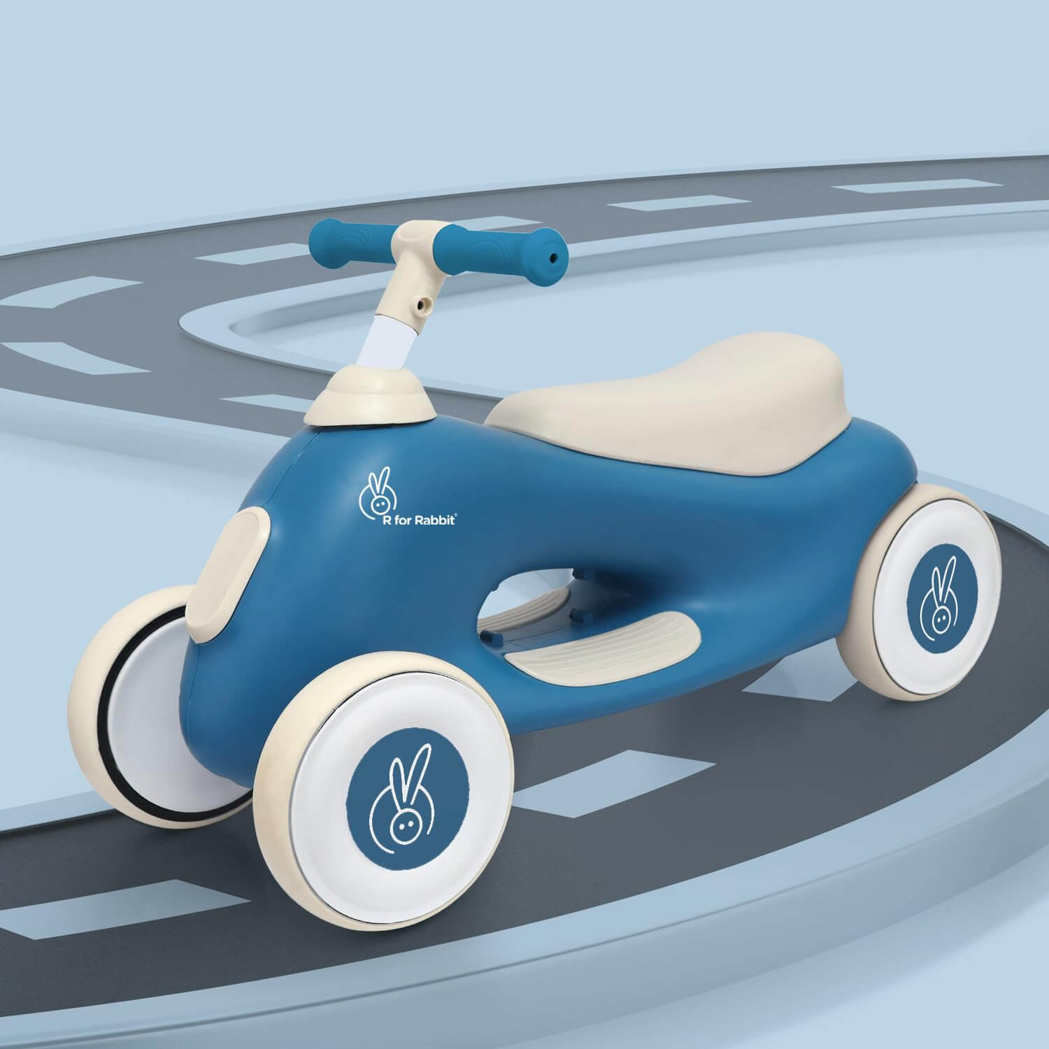 Blue and beige children's balance bike on a road-like surface with a light blue background