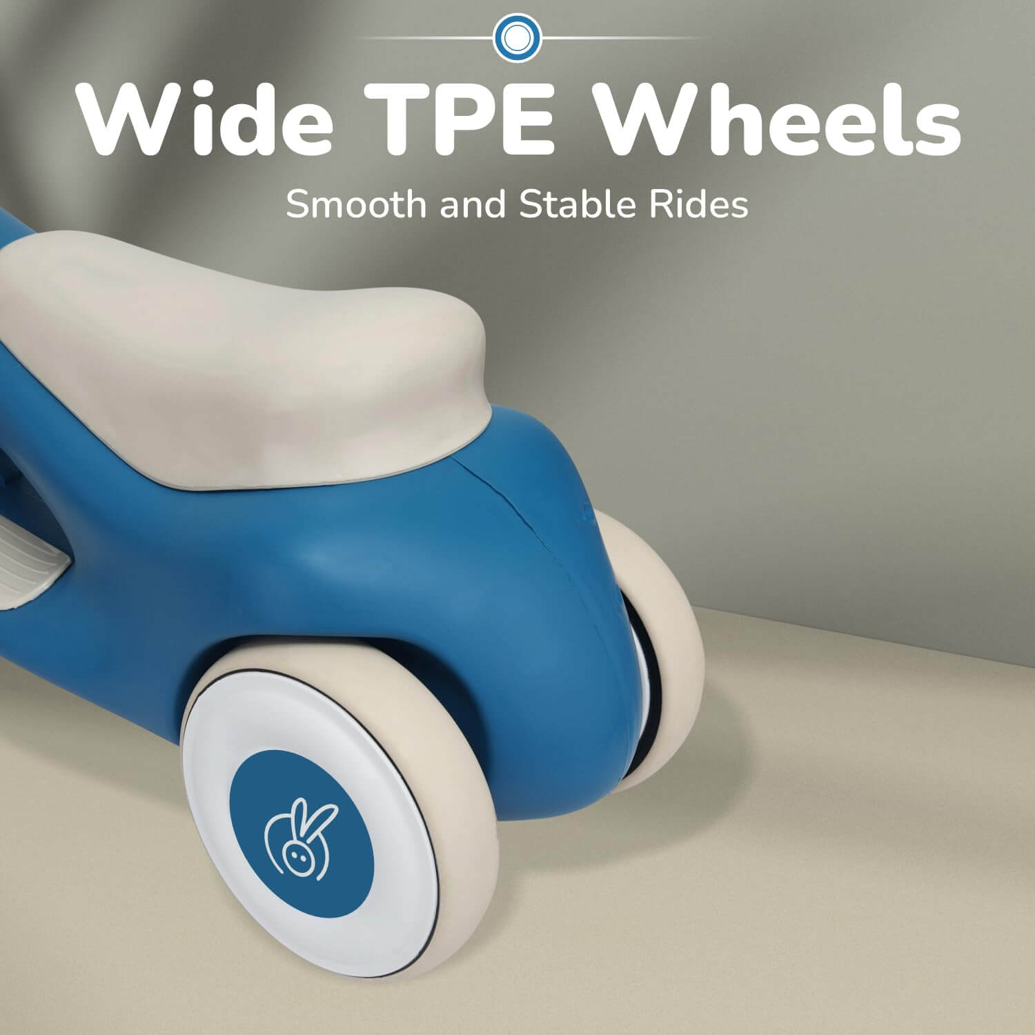 Children's push car with wide TPE wheels on a neutral background