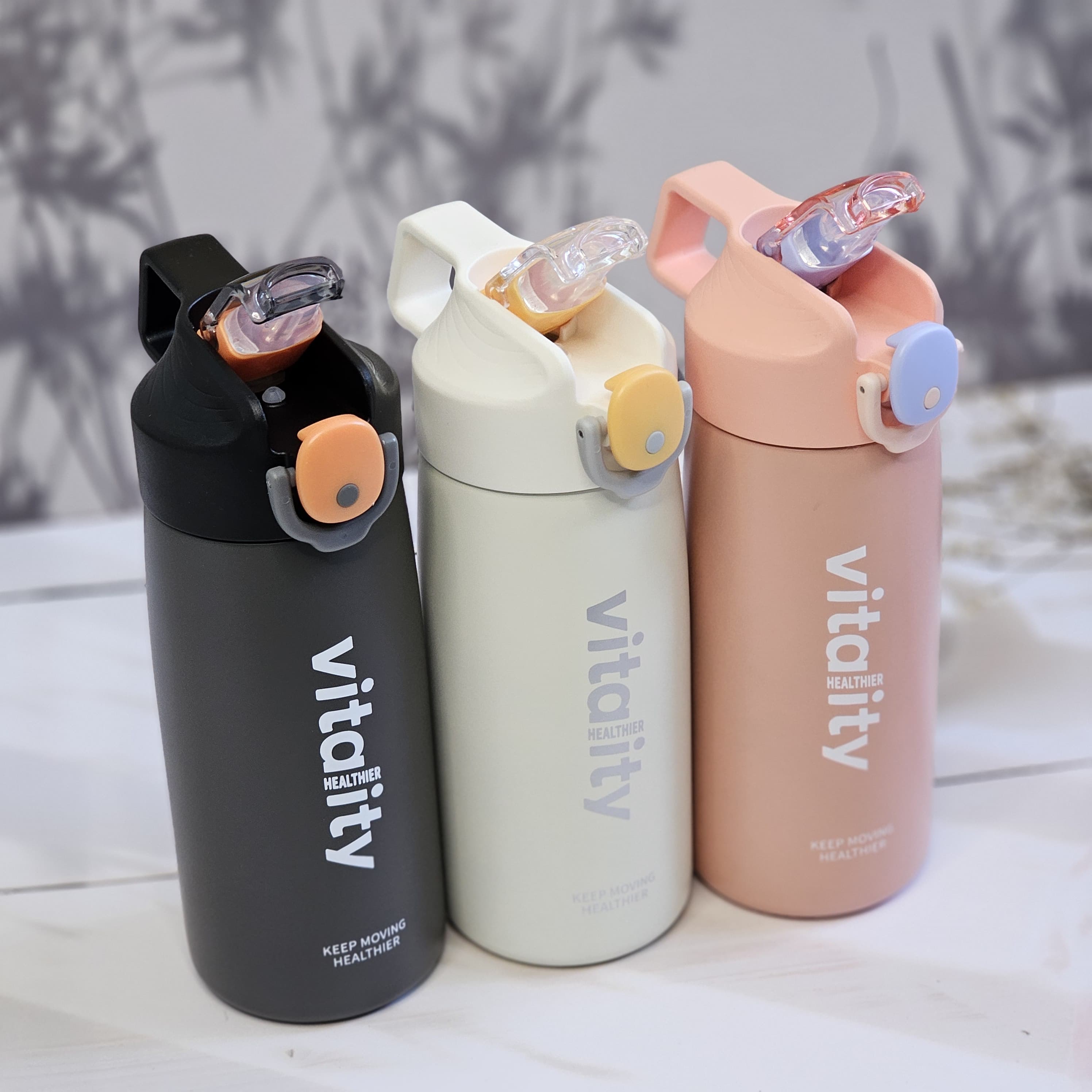 Stainless steel water bottles for kids and adults, featuring double-walled insulation, flip-top lids, and 'keep moving healthier www.usmile.toys