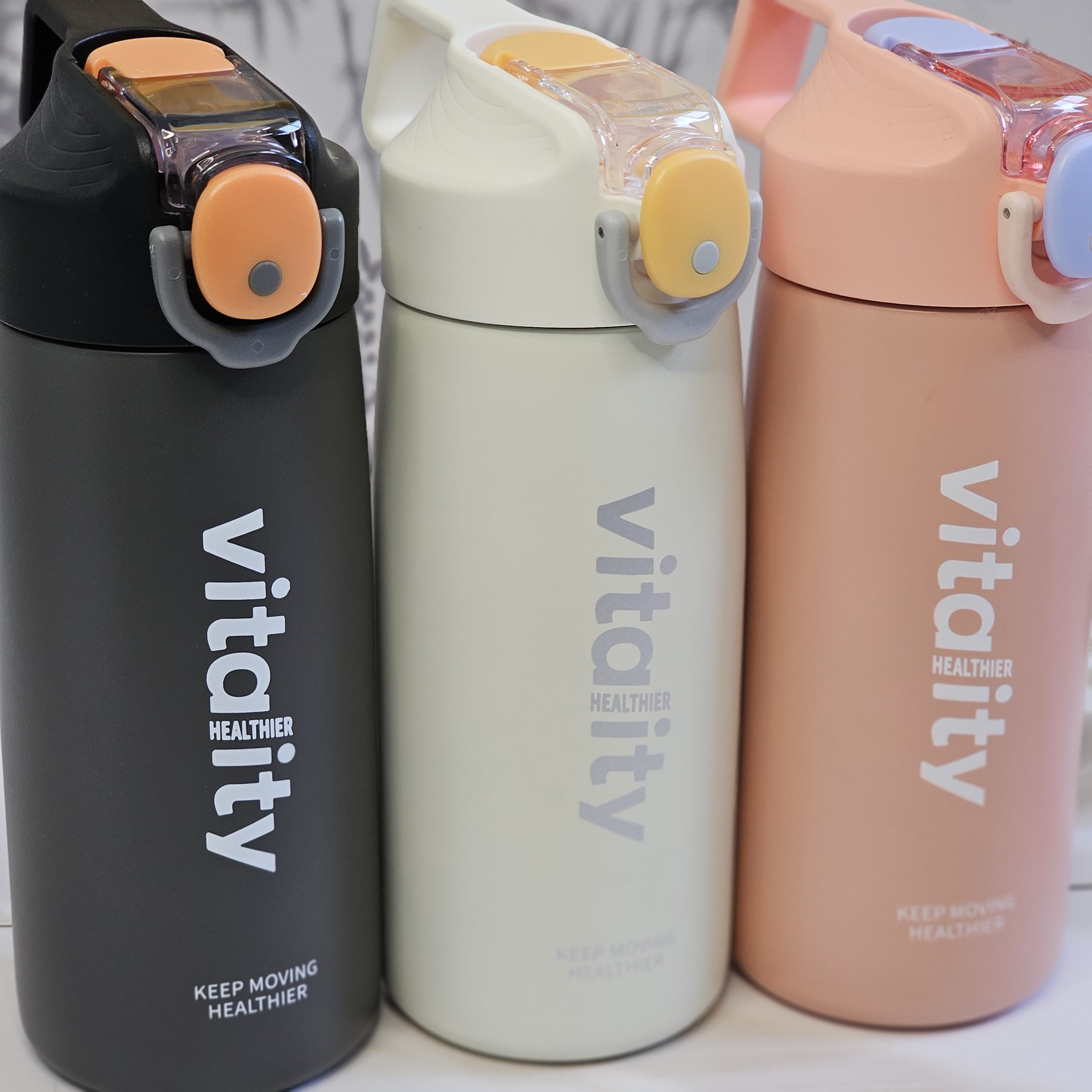 Stainless steel water bottles for kids and adults, featuring double-walled insulation, flip-top lids, and 'keep moving healthier www.usmile.toys