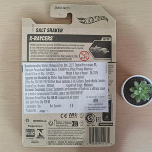 Hot Wheels X-Raycers salt shaker packaging on a wooden surface with a small plant. www.smile.toys