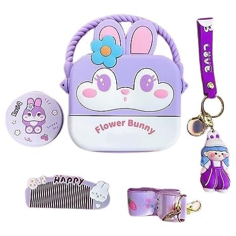 Usmile Toys cute purple silicone 'Flower Bunny' sling bag for girls, shaped like a cartoon rabbit face with a blue flower, accompanied by a matching compact mirror, comb, and a small doll." www.usmile.toys