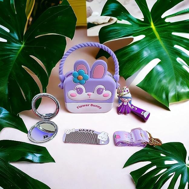 "Usmile Toys cute purple silicone 'Flower Bunny' sling bag for girls, shaped like a cartoon rabbit face with a blue flower, accompanied by a matching compact mirror, comb, and a small doll." www.usmile.toys