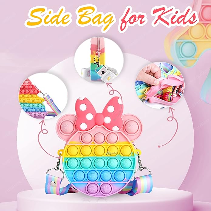 Usmile Toys Kids' rainbow-colored Pop It fidget crossbody bag with a large pink polka-dot bow, shown with fun keychains including a brown bear and a pink unicorn."
