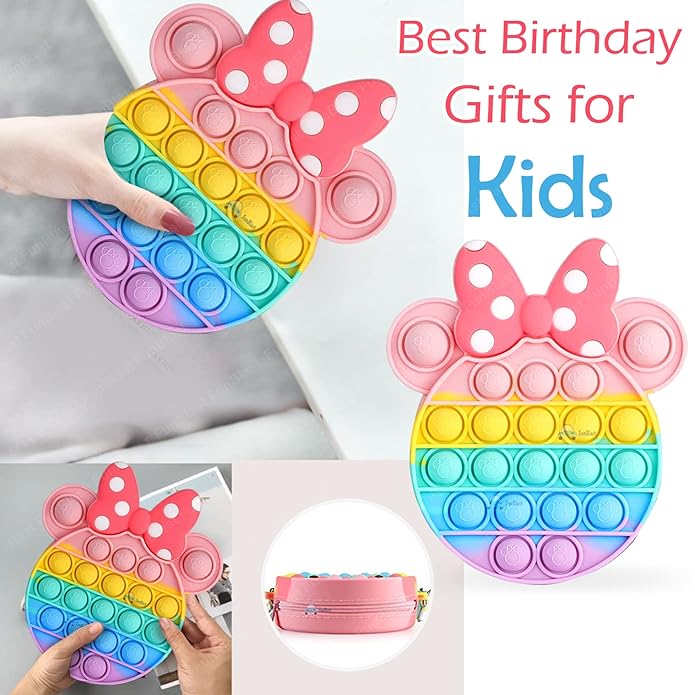 Front view of a Usmile Toys girls' sling bag, designed as a rainbow Pop It fidget toy with a prominent pink Minnie Mouse-style bow and a striped strap." www.usmile.toys