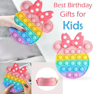 Front view of a Usmile Toys girls' sling bag, designed as a rainbow Pop It fidget toy with a prominent pink Minnie Mouse-style bow and a striped strap." www.usmile.toys