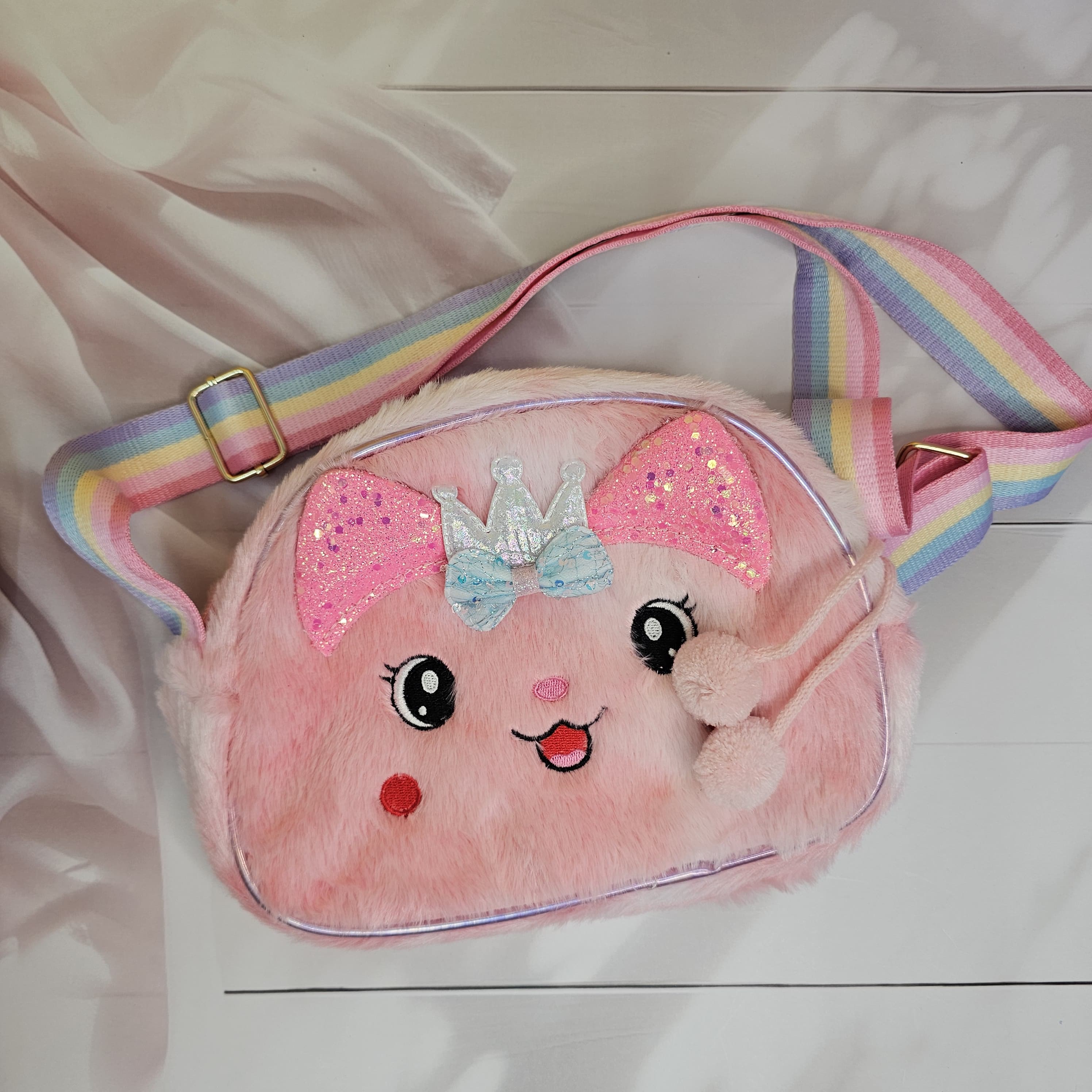 This charming plush bunny purse with sparkly details and a rainbow strap is a delightful sling bag for little girls www.usmile.toys
