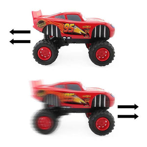 Red toy monster truck with large wheels on a white background