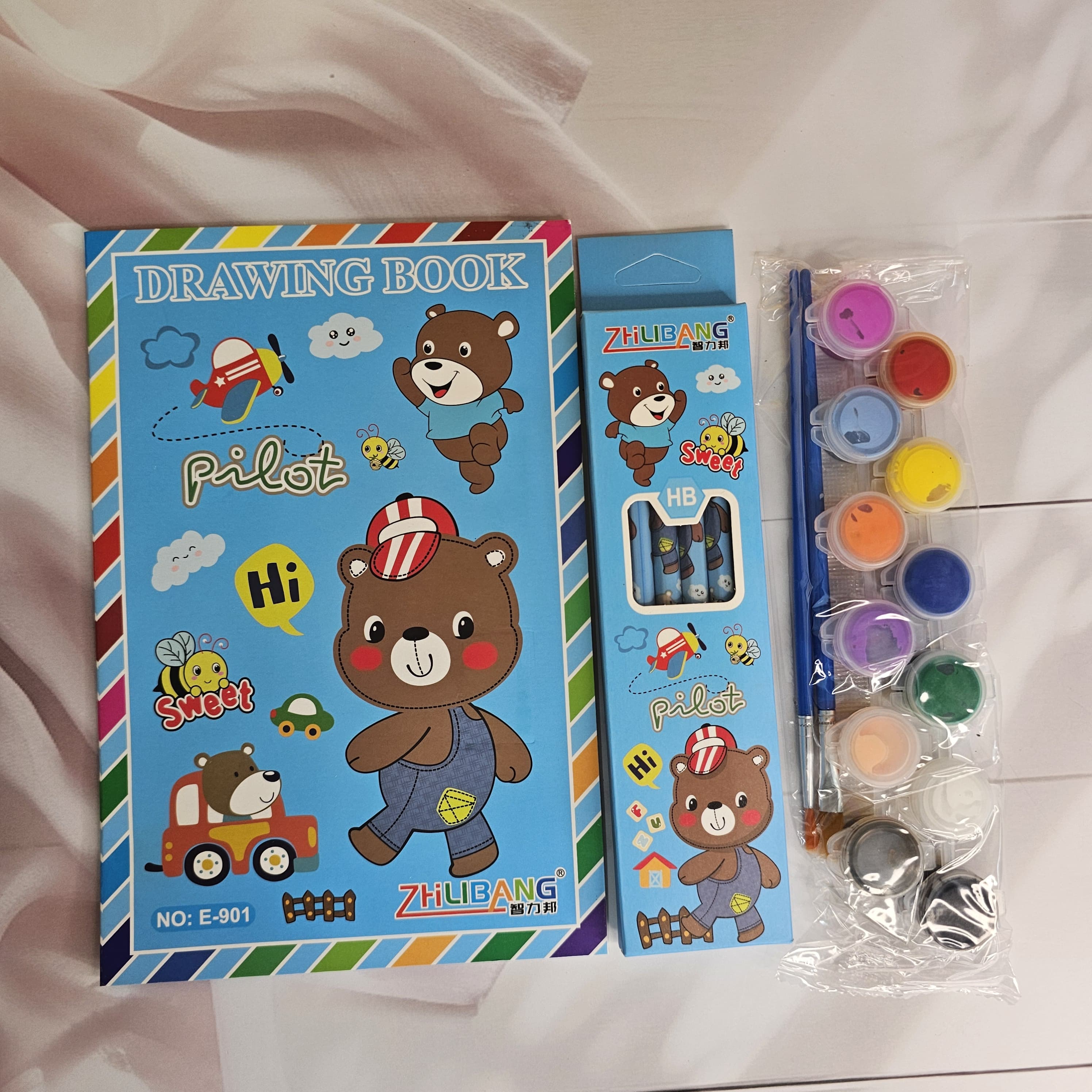 Colorful stationery kit for kids, featuring a dinosaur-themed drawing book and art supplies. www.usmile.toys