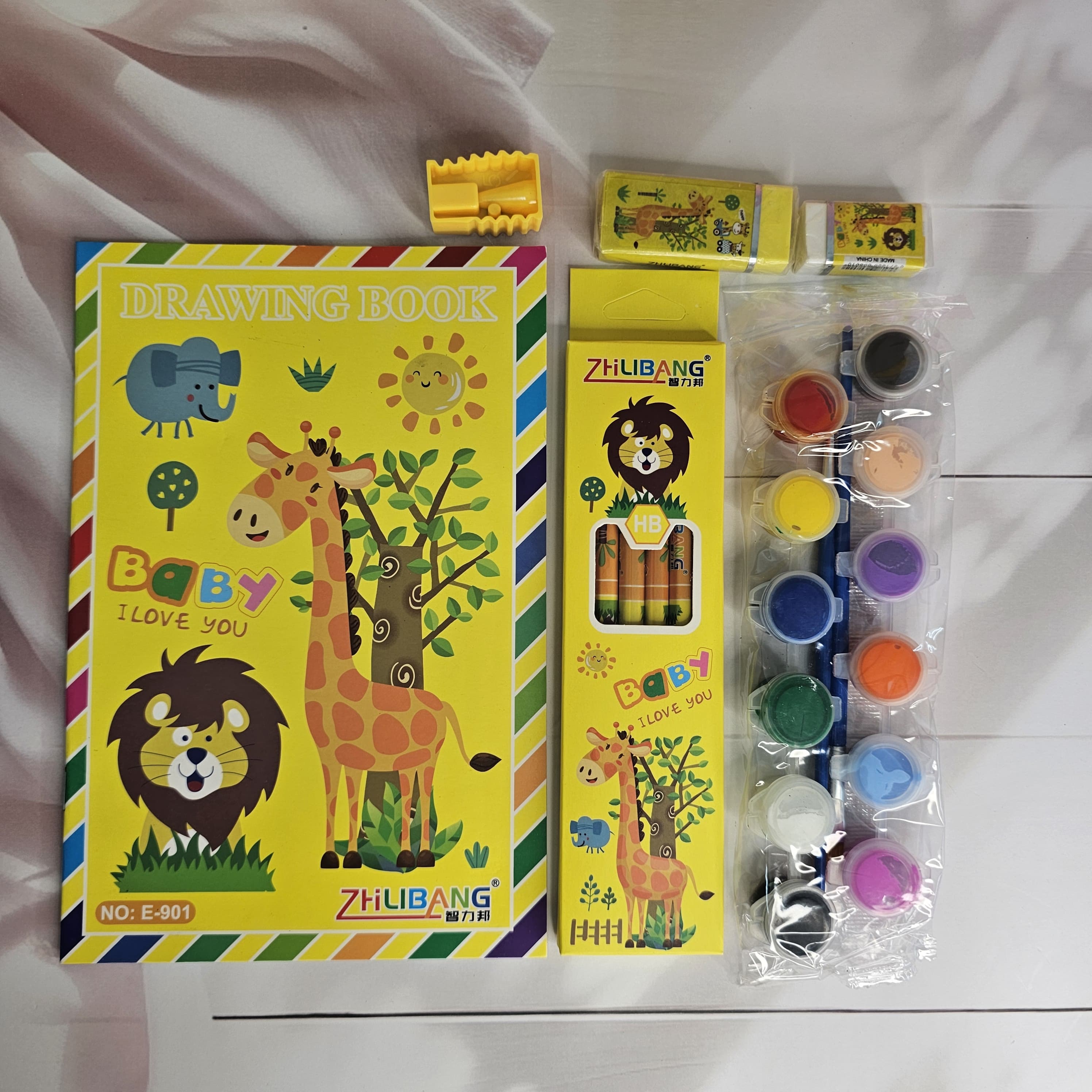 Colorful stationery kit for kids, featuring a dinosaur-themed drawing book and art supplies. www.usmile.toys