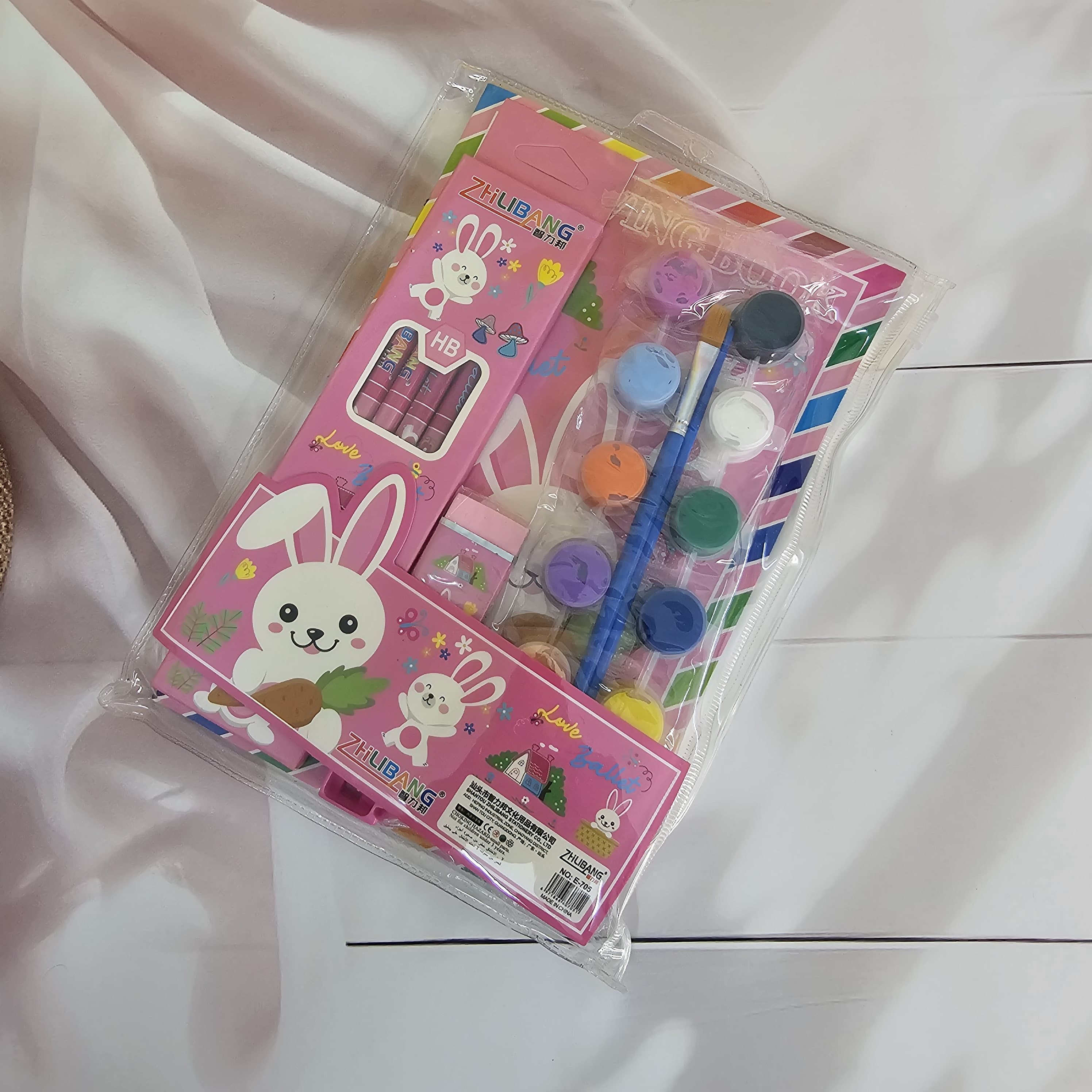 Colorful stationery kit for kids, featuring a dinosaur-themed drawing book and art supplies. www.usmile.toys