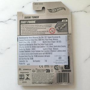 Hot Wheels Sushi Tuner toy packaging on a marble surface