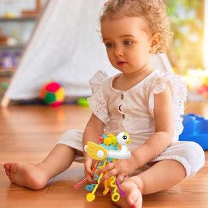 "Usmile Toys 'Happy Baby' swan pull string toy, designed as a rattle and teether with vibrant colors, stimulating infant sensory development."