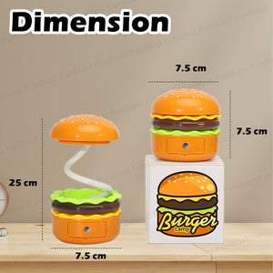 Fun orange and green burger-shaped rechargeable table lamp with a flexible white neck, providing desk light. Surrounded by other playful figurines, ideal for kids' rooms or adult desks. From uSmile.toys." www.usmile.toys