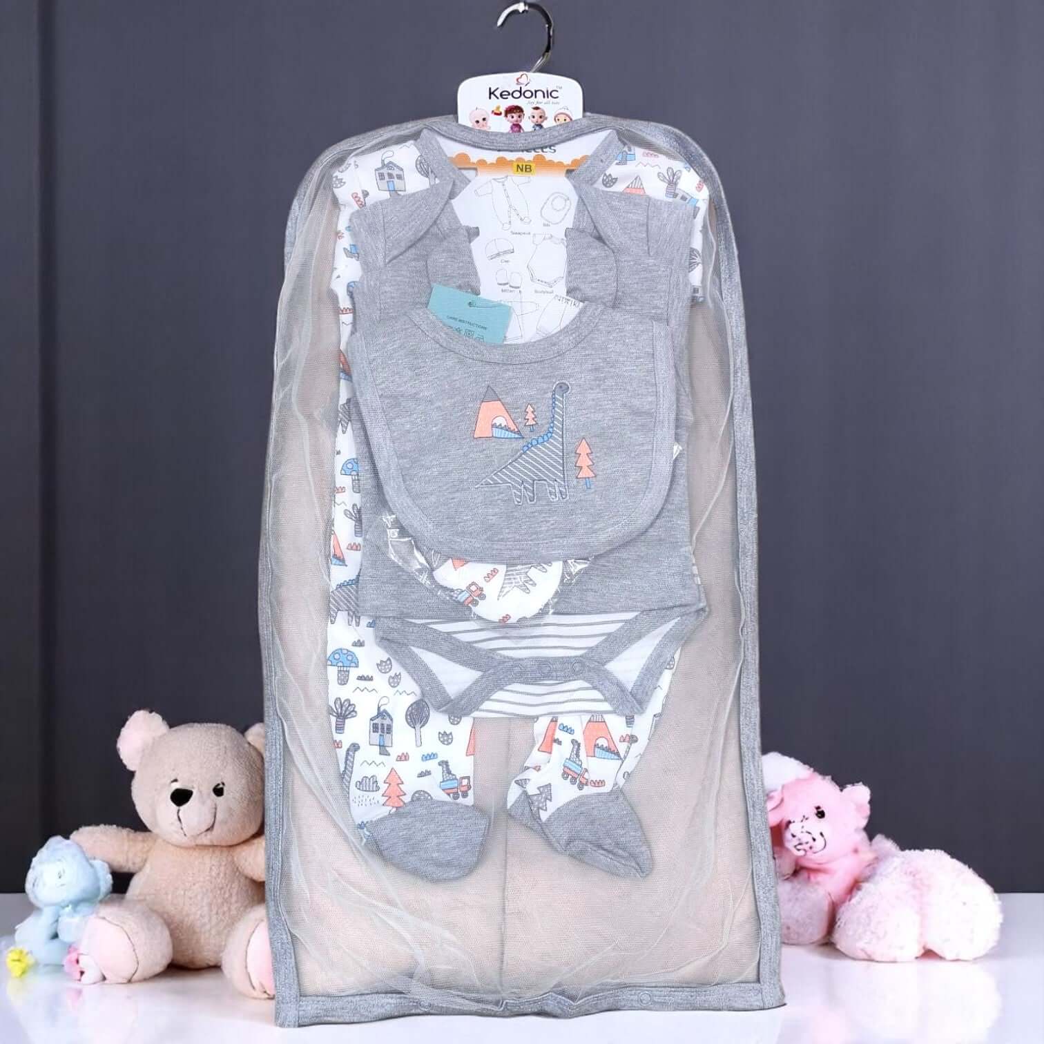 "Full view of a 7-piece newborn baby clothing set, featuring a grey and white dinosaur print, including bodysuits, pants, bib, and cap, available at uSmile.toys. www.usmile.toys