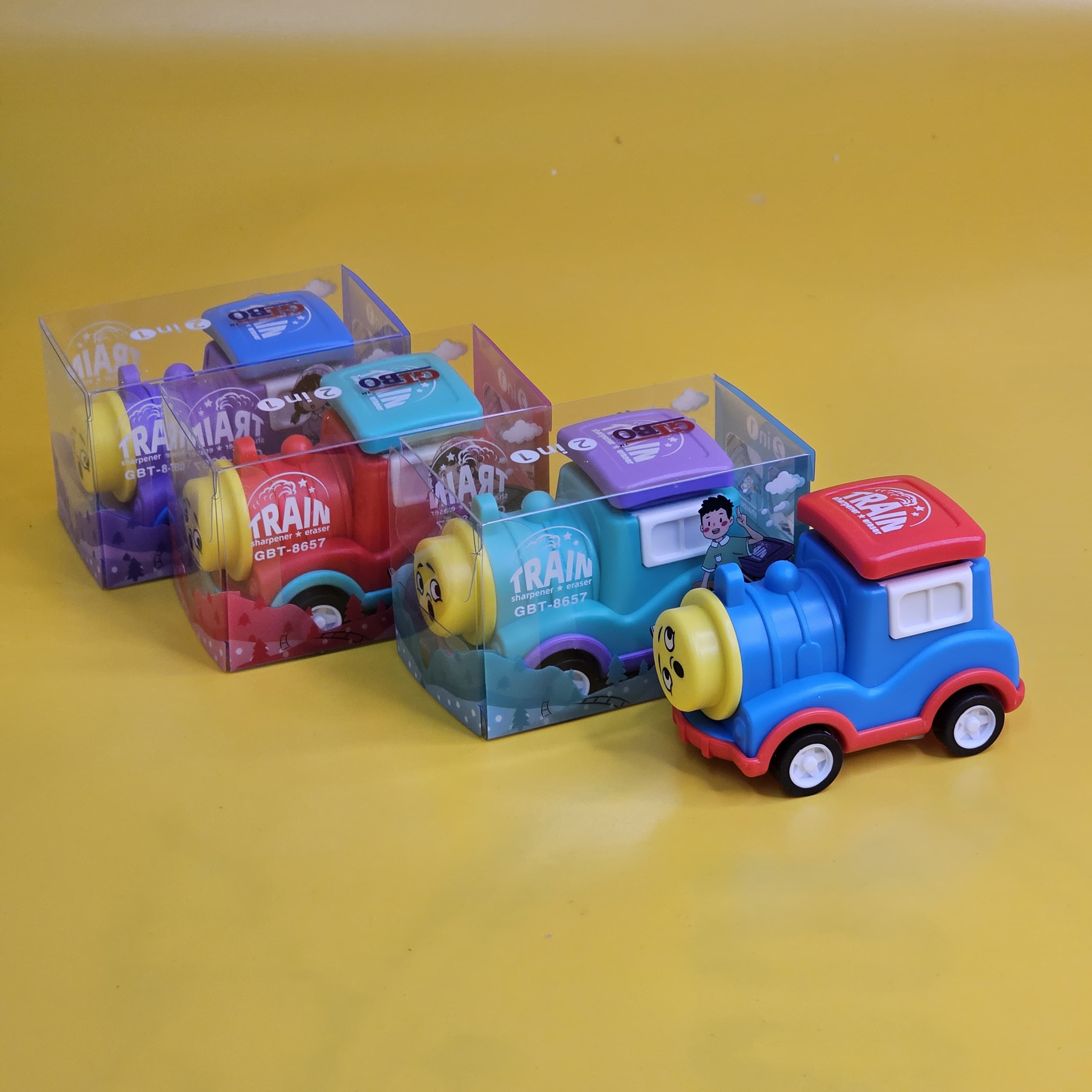 Set of four multicolour train-shaped pencil sharpeners with built-in erasers for kids' stationery www.usmile.toys
