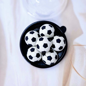 mini sports ball erasers for kids, including green tennis, black and white soccer, and blue/yellow volleyball designs. www.usmile.toys