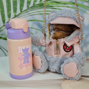  "Pair of Usmile Toys SS Insulated Vacuum Water Bottles, featuring adorable teddy bear carry covers: one light grey with a pink hooded outfit, and one brown with a black faux leather jacket." www.usmile.toys