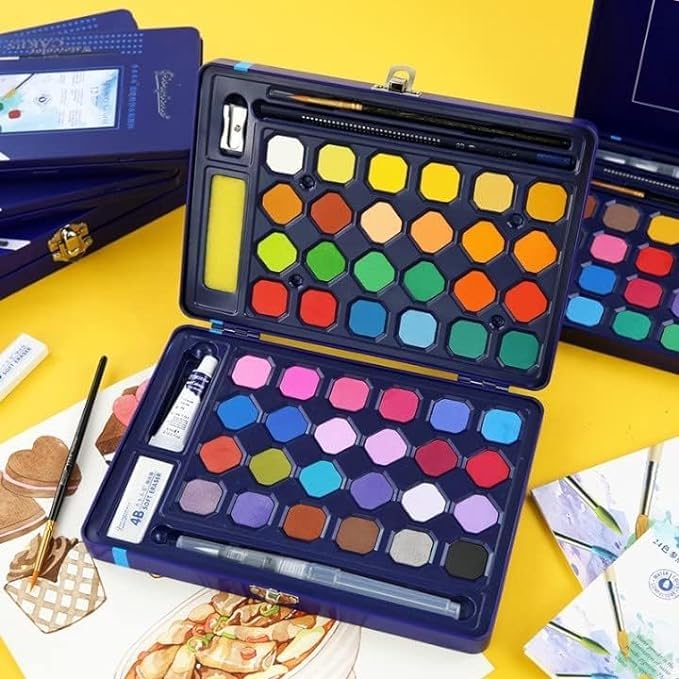 Open blue metal case revealing a watercolor paint set of 48 vibrant hexagonal shades across two layers, including a water brush, pencil, sharpener, and white paint tube. Perfect for artists and kids from uSmile.toys." www.usmile.toys