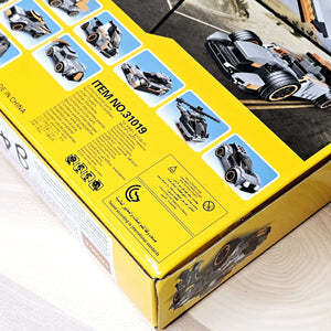 Front of the product packaging for a building block toy set, showing a constructed gray jeep-like vehicle and a character figure against a desert road background, promoting imaginative play from Usmile Toys. www.usmile.toys