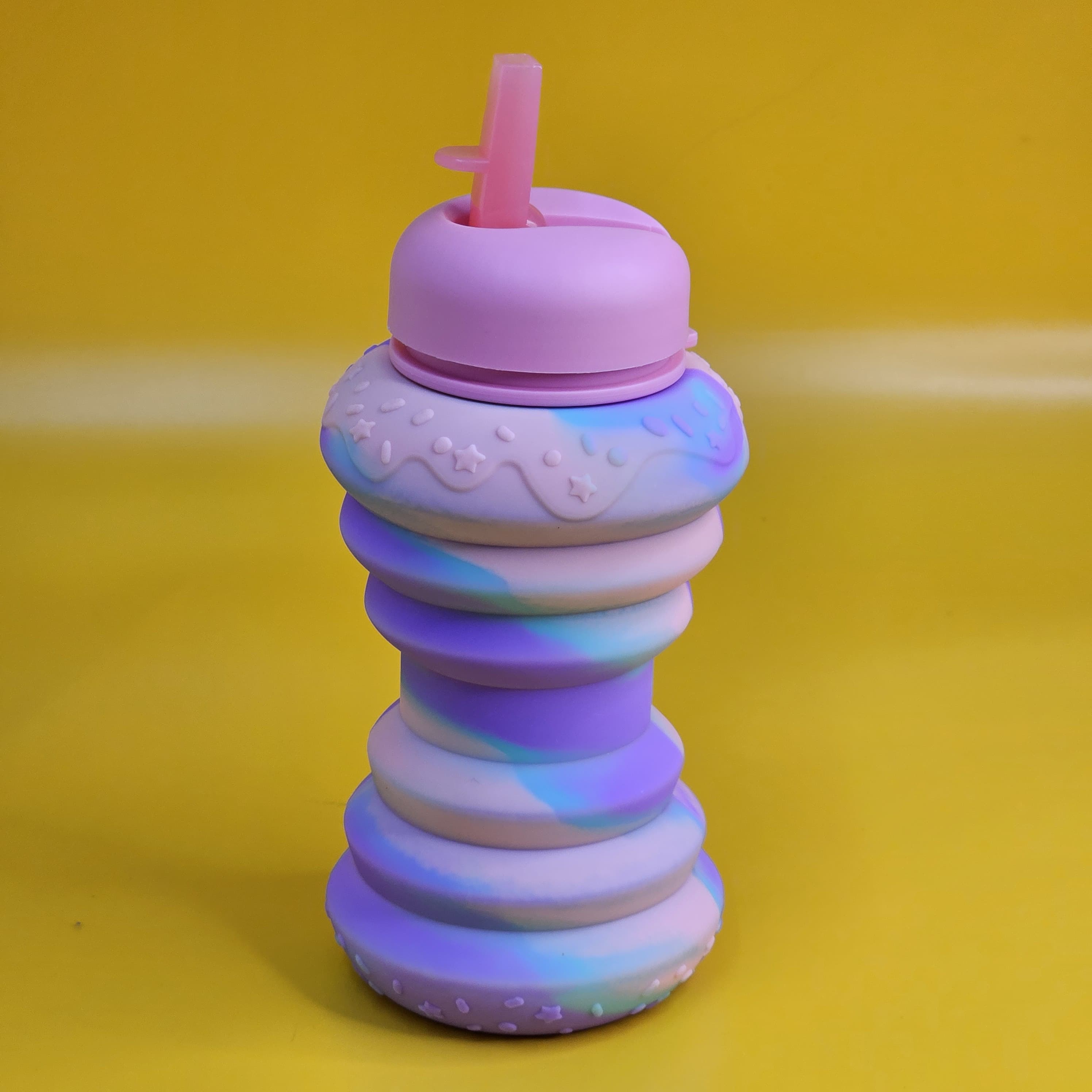 BPA-free and collapsible silicone sipper bottle with a playful donut design, perfect for school, travel, and playtime for kids www.usmile.toys
