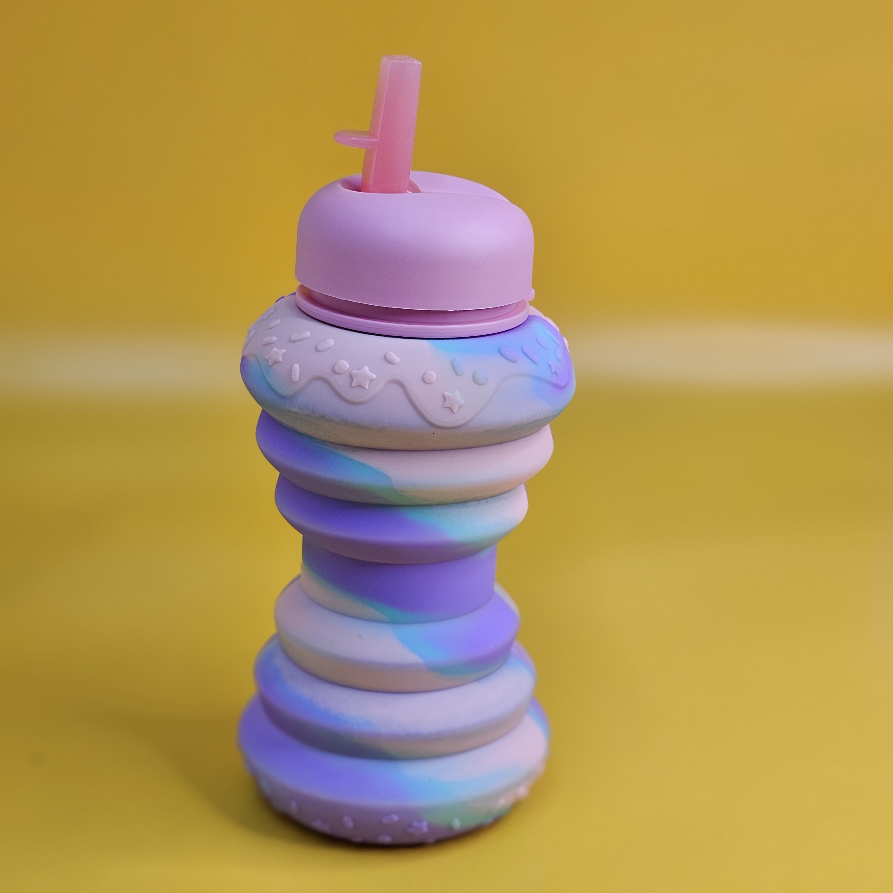 BPA-free and collapsible silicone sipper bottle with a playful donut design, perfect for school, travel, and playtime for kids www.usmile.toys
