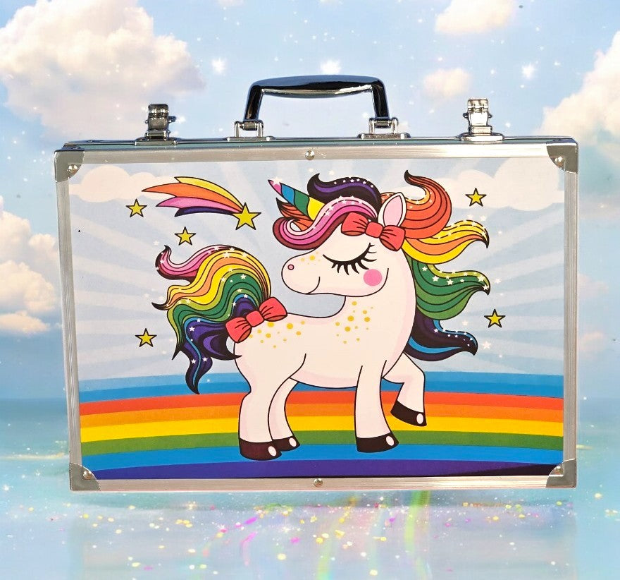 A silver art suitcase with a unicorn design is opened to reveal a comprehensive set of art supplies, including crayons, watercolor paints, watercolor pens, color pencils, watercolor cakes, mini crayons, paint brushes, erasers, palettes, and HB/2B pencils