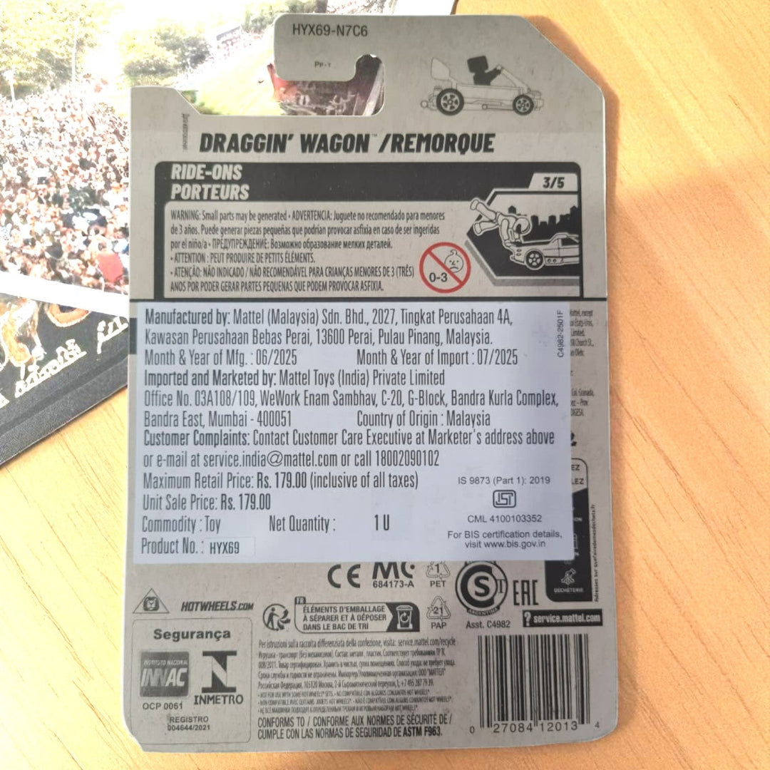 Back of a toy packaging with branding and product details on a wooden surface