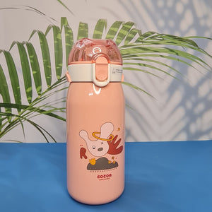 A set of four colorful, insulated stainless steel water bottles designed for children. Each bottle features a flip-top straw lid, cute cartoon animal illustrations (dinosaur, hedgehog, bear chef, elephant with 'E'), the "Cocoa" brand name, and a detachable "LOVELY" patterned shoulder strap. Ideal for keeping drinks cold or warm on the go